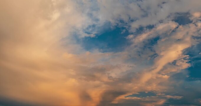 Beautiful pink sunset clouds with small moon appearing in blue sky time lapse