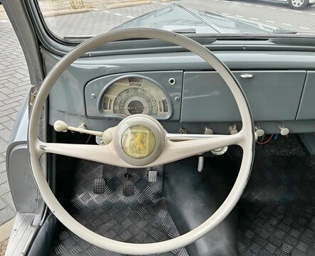 Peugeot vintage car interior with steering wheel and dashboard