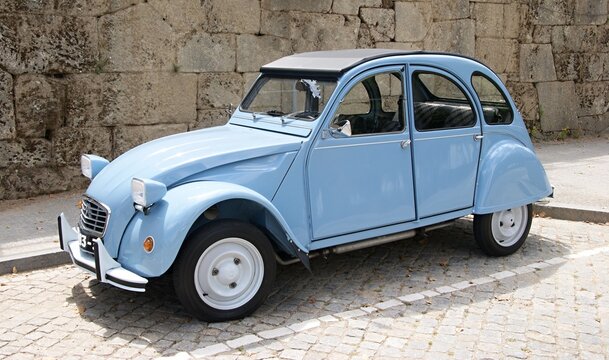 Citroen 2CV classic car parked on cobblestone street