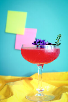 Close-up Colorful Homemade Fruity Cocktail Mixology Drink Glass Flower Garnish with Post-it Attached on the Wall Setup on Yellow Cloth Pop Art Style