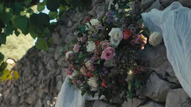 Floral Wedding Arrangement on Rustic Stone Wall