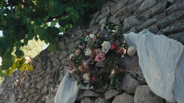Wedding Floral Arrangement on Rustic Stone Wall