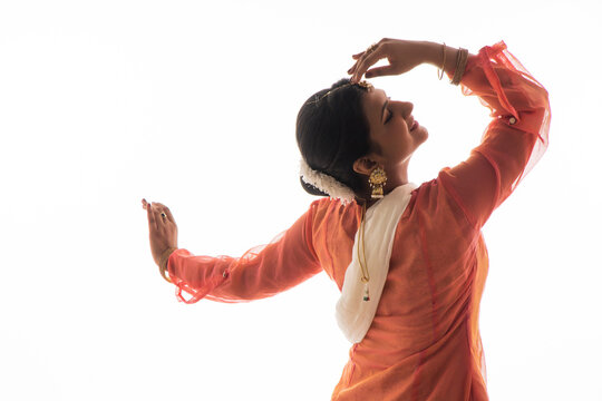 Graceful Kathak dancer giving a mesmerising performance in front of a white background. 