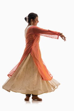 Graceful Kathak dancer giving a mesmerising performance in front of a white background. 