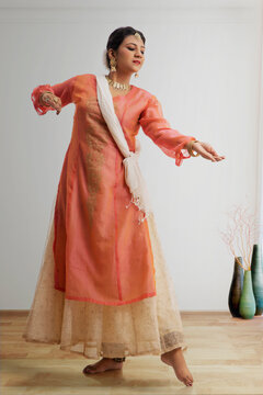 Graceful kathak dancer performing at home.