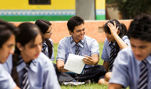 Students sitting in the garden of a school