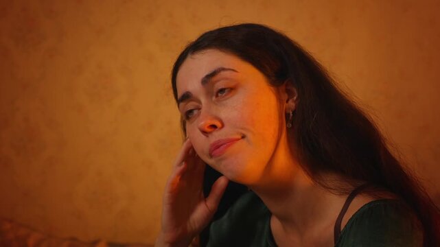 Portrait of a yawning young Caucasian woman using a smartphone with a tired and bored expression. Fatigue, digital overload, lack of sleep, and modern lifestyle stress concept