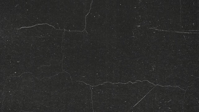 Abstract dark gray concrete wall surface with fine cracks and weathered texture.