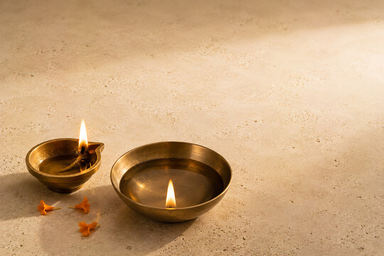 Traditional diwali oil lamp and brass bowl with floating flame floating tradition festival celebration spiritual blessings decoration marigold devotion celebrate serenity meditation