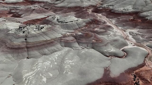 High aerial pan around the colorful Bentonite Hills in Utah desert