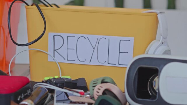 Electronic waste collection container with old technology gadgets for recycling and disposal