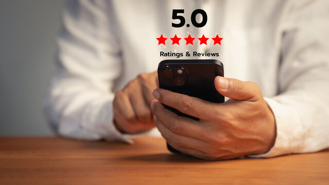 Business man using smartphone to give five star rating and review. Concept of excellent customer service, high satisfaction feedback, and successful digital business reputation.