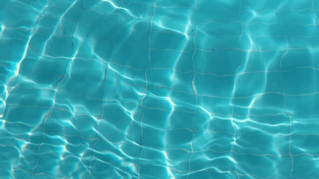 Turquoise swimming pool water ripples with sunlight refraction