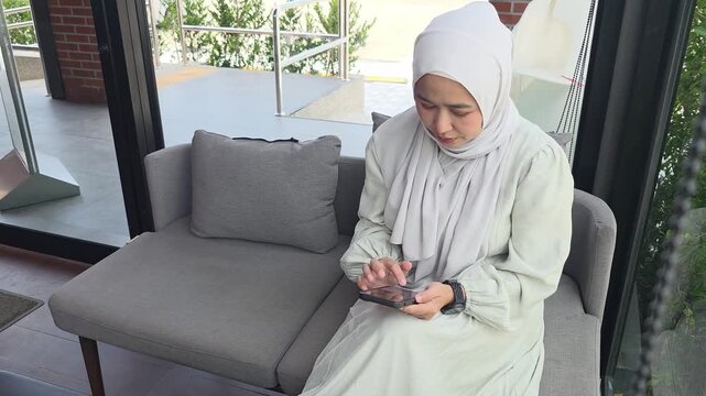 Muslim consumer focusing on smartphone interface showcasing modern digital connectivity and telecommunication technology