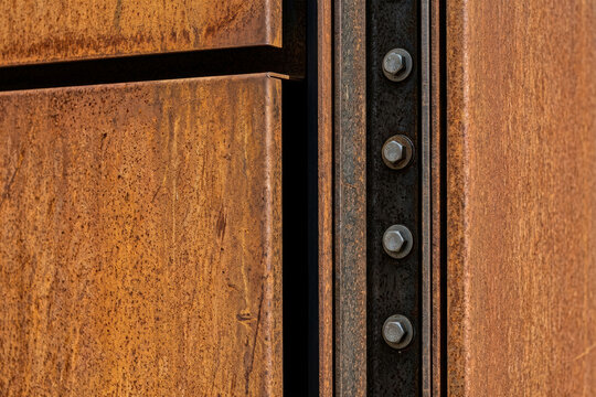 Rusty metal panels with industrial bolts