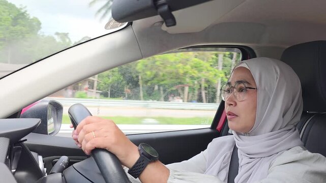 Muslim adult operating automobile vehicle showcasing independent modern transportation lifestyle and deep commuting concentration
