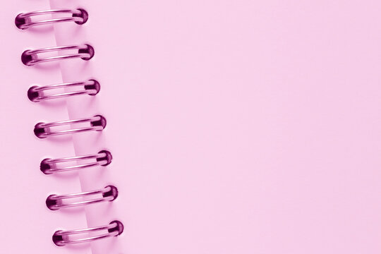 close up of light pink page of sketchbook with metallic spiral binder