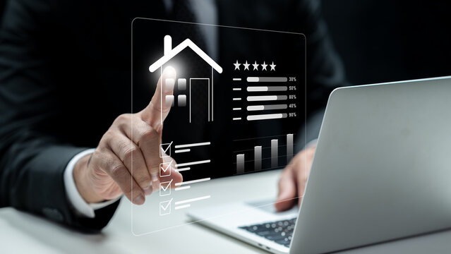 A businessman interacts with a digital screen displaying property ratings, checklists, and market charts while using a laptop. Concept of Appraiser