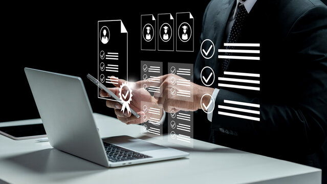 A business professional in a suit uses a digital device to review candidate profiles and resumes with augmented reality holographic icons. Concept of Recruitment Qualification