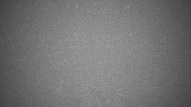 Abstract gray grunge texture with subtle grain and light leaks.