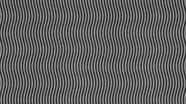 Abstract monochrome pattern with repeating vertical wavy lines.