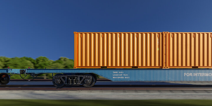 Profile view of orange cargo container on moving railway flatcar