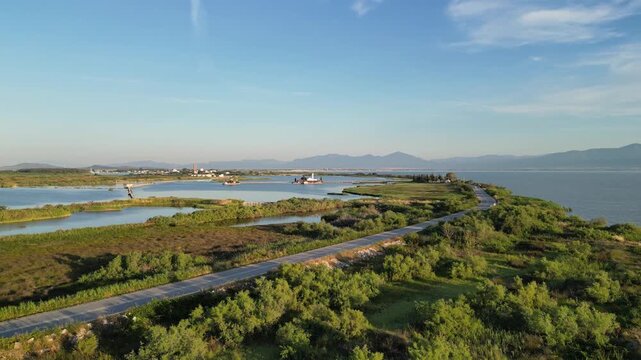 Drone Flying Toward Porto Lagos Monasteries Across Lagoon at Golden Hour, Greece