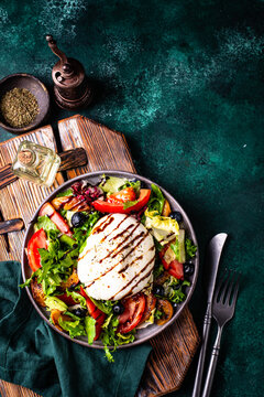 Salad with fresh burrata cheese, grilled peaches and blueberry