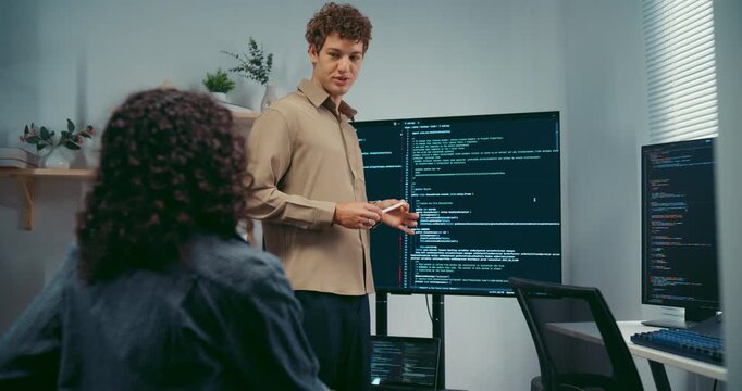 Diverse team software developer present coding on screen to colleague at office. Mentor coaching program leader, Creative startup teamwork discussion, Artificial intelligence system workshop concept.