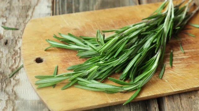 Fresh rosemary sprigs on a wooden board. Seasoning.