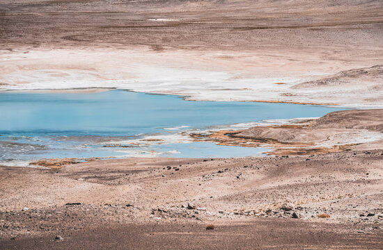 A lake with blue water on a high-altitude rocky plateau in the Pamirs, a mountain landscape with a lake and rocks in the desert, a combination of colors in nature