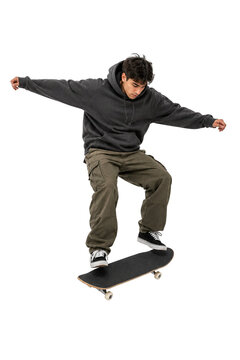 Skateboarder performing a trick in a hoodie and cargo pants isolated on transparent background