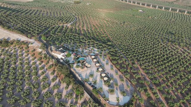 An aerial view of the Finca Fuente la Parra estate in the Andalusian city of Lucena, surrounded by greenery on a sunny evening