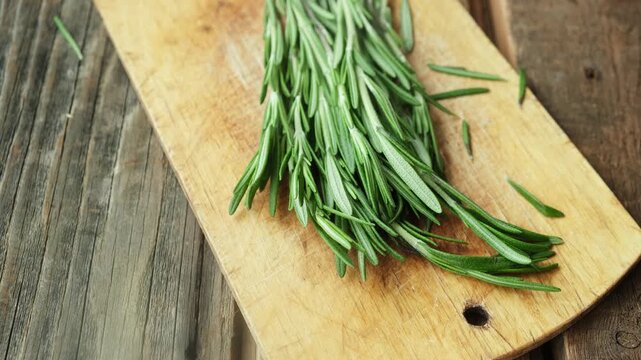 Fresh rosemary sprigs on wooden board. Seasoning.