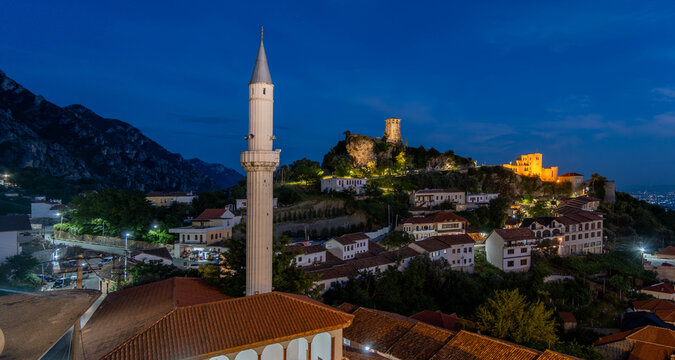 Kruja castle and mosque minaret illuminated at twilight Albania