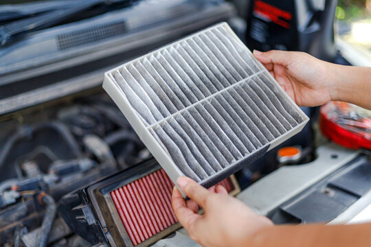 Hand of Woman Holding Dirty Cabin Air Filter