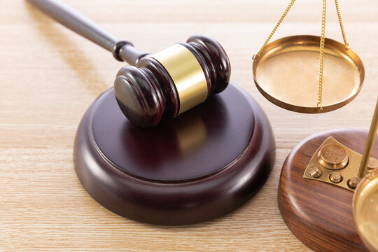 Judge Gavel and Scales of Justice on Wooden Desk Representing Law, Courtroom and Legal Authority