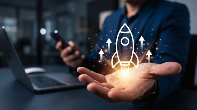 Startup business concept, Businessman presenting virtual rocket launch above hand for fast startup business. Strategic planning, innovation and sustainable business growth.
