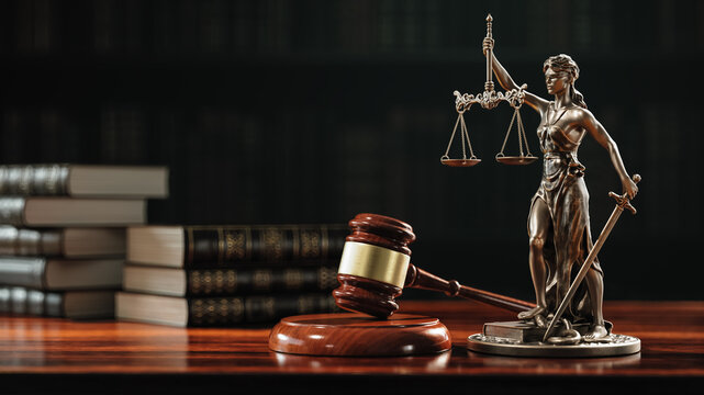 Lady Justice Statue, Judge Gavel and Law Books on Courtroom Desk Representing Legal System and Justice
