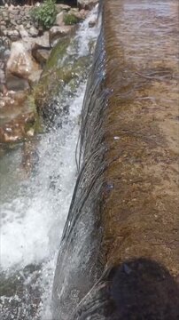 Cinematic Close Up of Refreshing Fresh Water Stream Cascading Over Rocks
