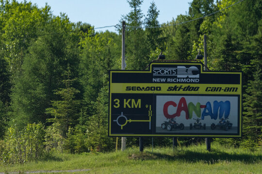 Gaspesie, Canada, 17 June 2026 : A large roadside billboard advertises Sports DC, Sea-Doo, Ski-Doo, and Can-Am recreational vehicles near New Richmond.