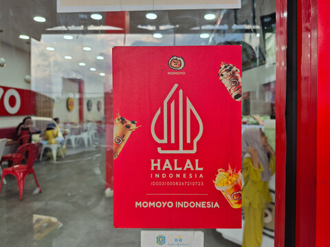 ​Indonesian Halal Logo Sign on Red Poster Board in Ice Cream Store Interior