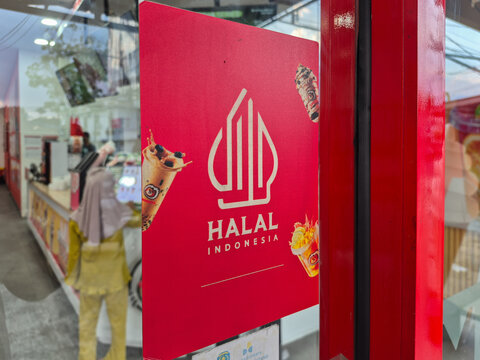 ​Indonesian Halal Logo Sign on Red Poster Board in Ice Cream Store Interior