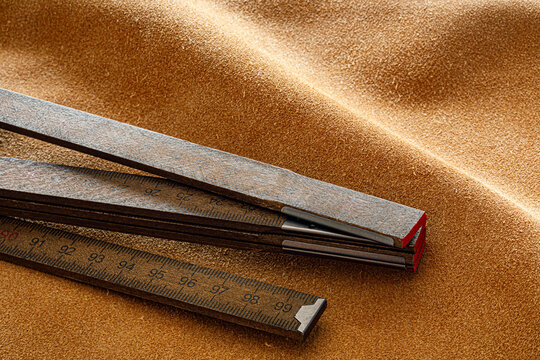 Vintage Folding Wooden Ruler on Brown Suede Leather Surface Macro