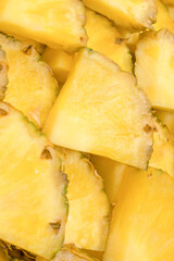 Obraz premium Pineapple juicy yellow slices as a background.