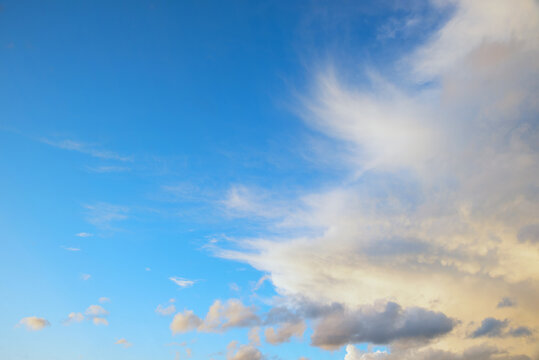 Cirrus clouds in strong winds in the upper layers of the atmosphere; blue sky with space left