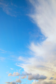 Cirrus clouds in strong winds in the upper layers of the atmosphere; cumulus clouds below.