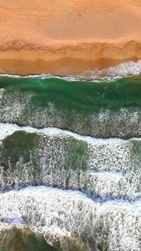 The beach displays a serene landscape with golden sands, calming waves. Italy