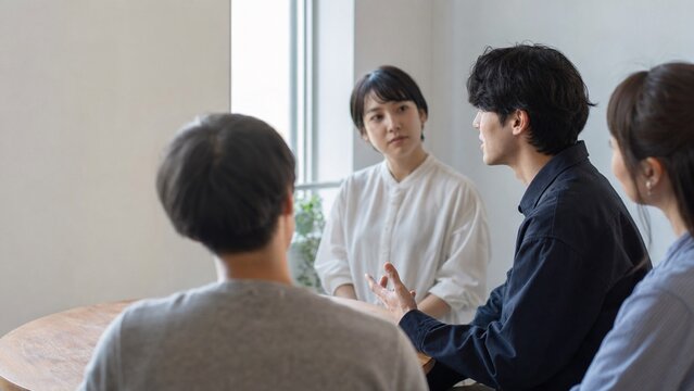 横顔で率直な意見を伝える社員と耳を傾ける同僚