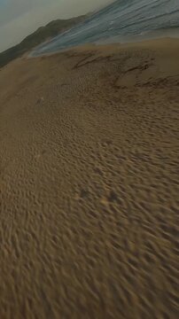FPV drone flying fast along a beach. Sardinia, Italy